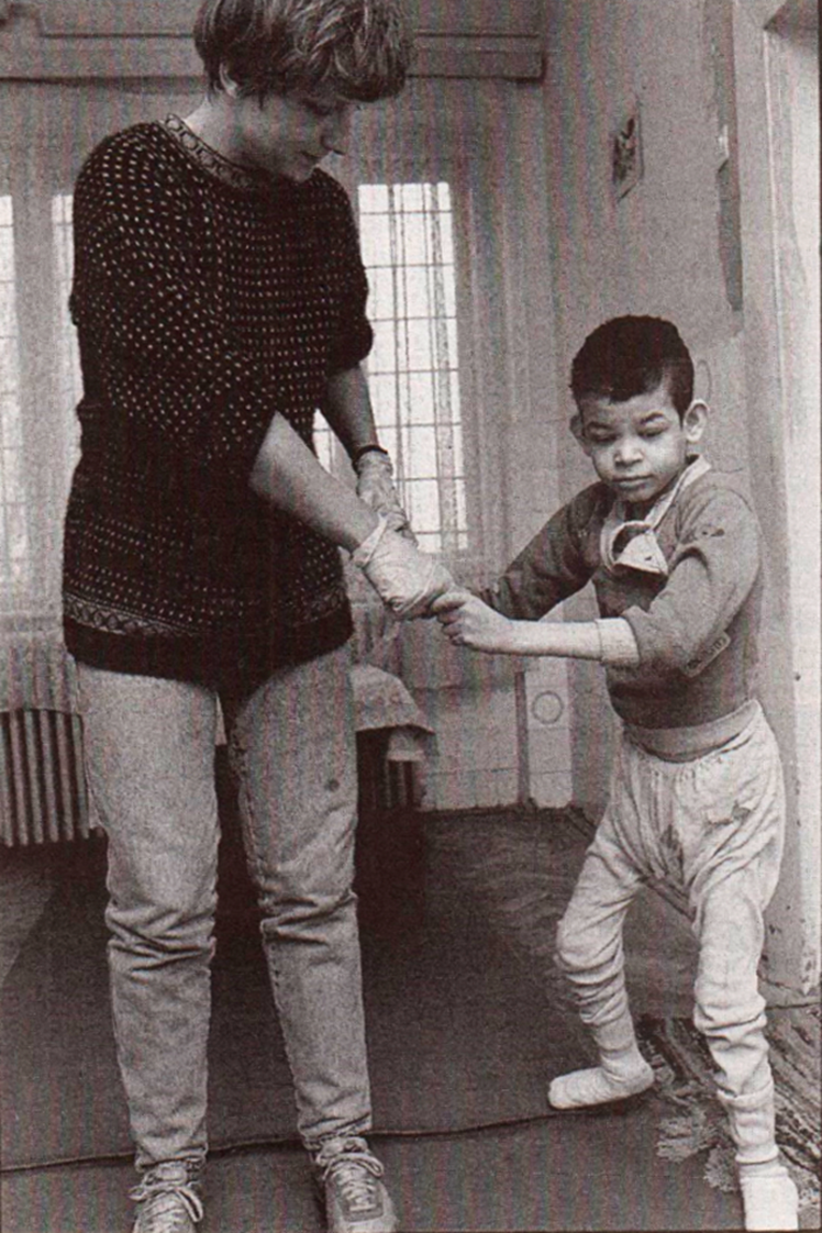 1991: En socialpædagog arbejder med et ’tremmesengsbarn’ på et psykiatrisk hospital i Rumænien. Efter diktator Nicolae Ceaușescus fald sender forbundet med hjælp fra flere fonde og organisationer 20 socialpædagoger til Rumænien for at hjælpe landets fagfæller med at forbedre forholdene for udviklingshæmmede børn, der henslæbte barndommen under kummerlige forhold. - Arkivfoto Kurt Johansen